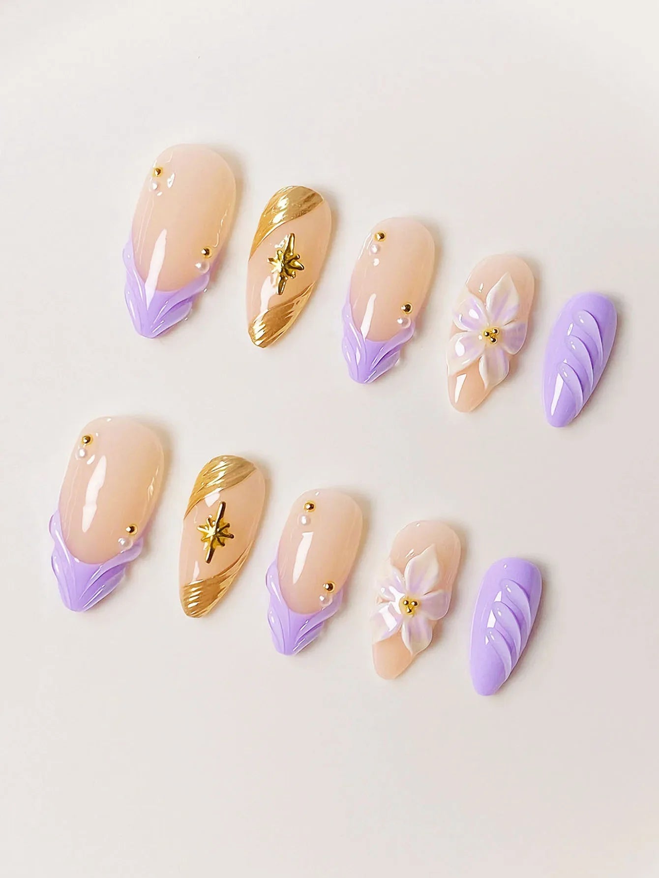 10 handmade almond-shaped press-on nails with purple water ripple design and starburst pattern in a high-end style.